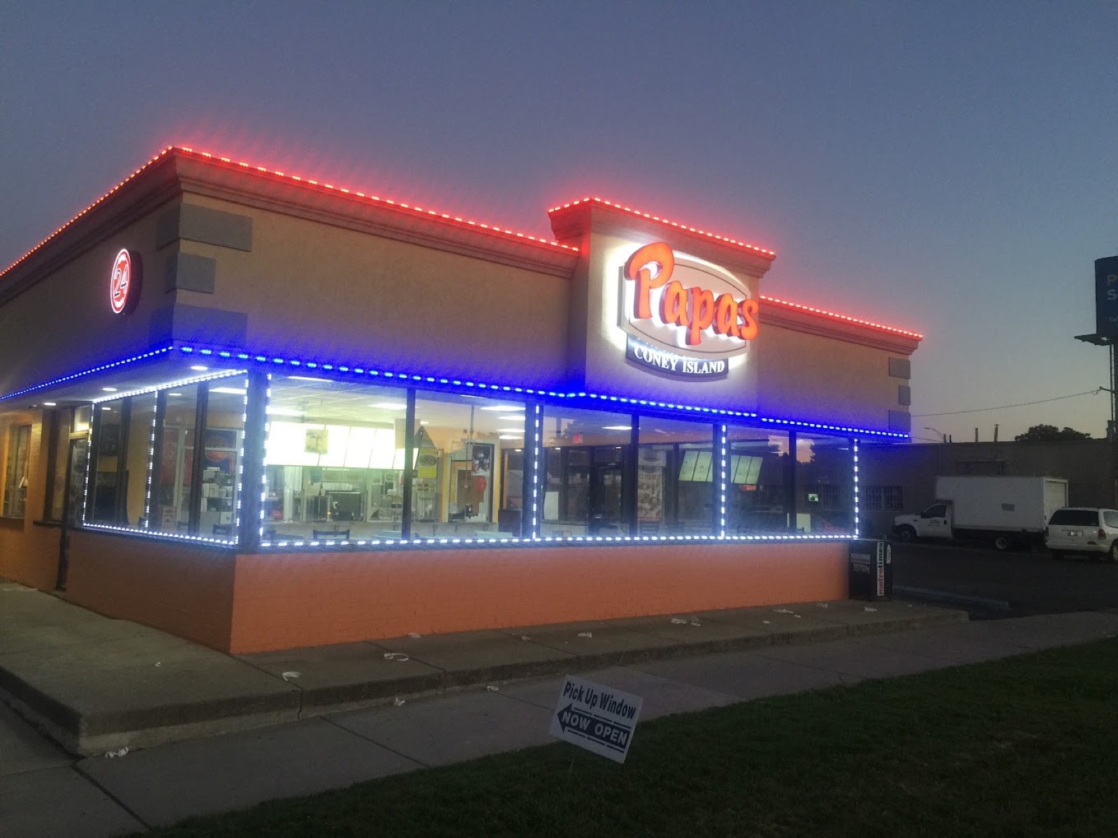 Papa's Coney Island lit up at night with neon signage